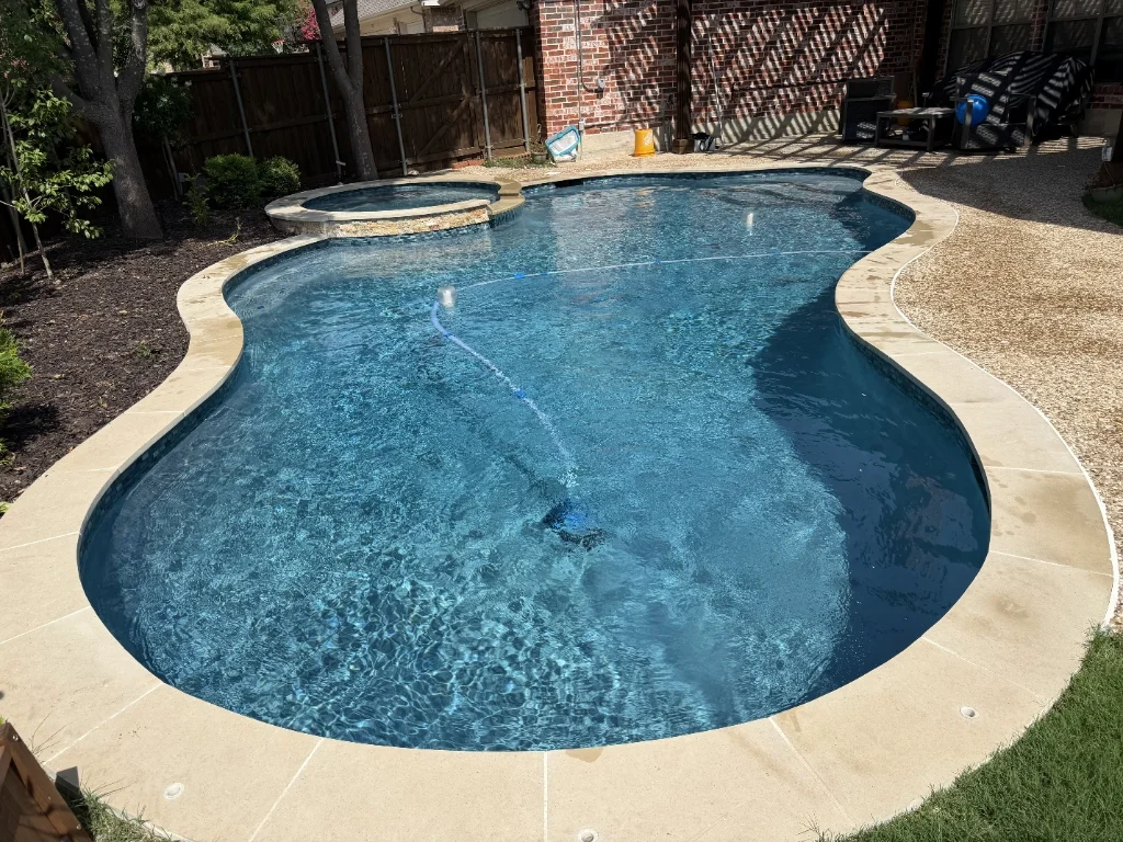 Technician cleaning wide pool with pole
